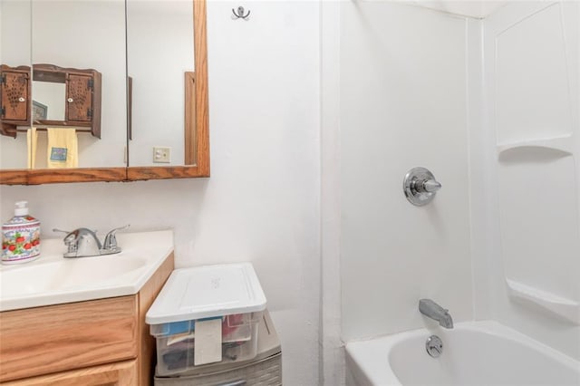 bathroom featuring washtub / shower combination and vanity