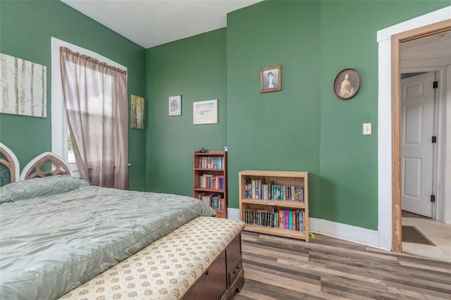 bedroom with wood finished floors and baseboards