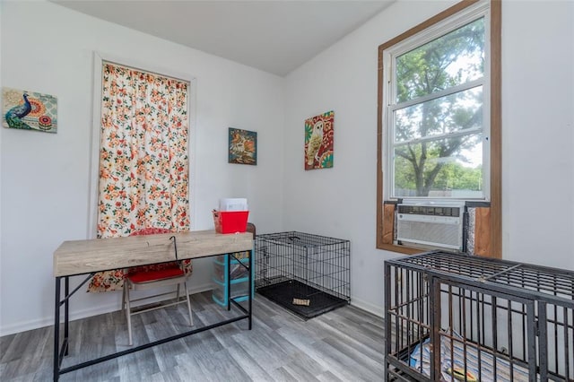 office with wood finished floors, baseboards, and cooling unit