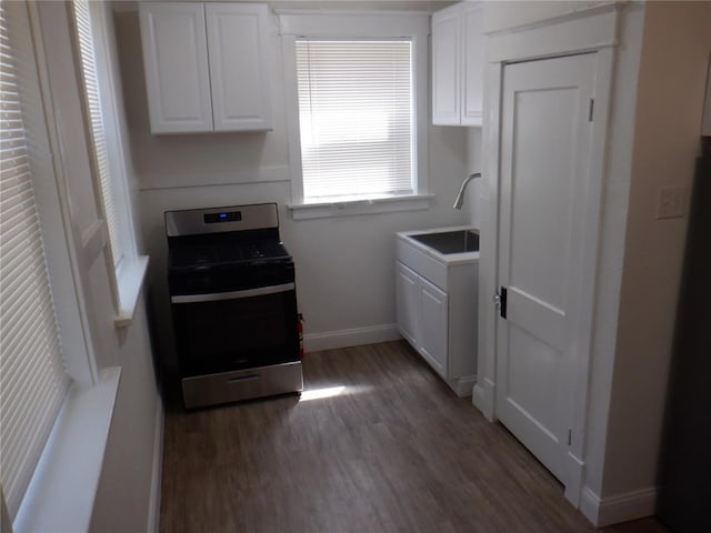 5335 Bancroft Ave, Saint Louis, MO 63109 - kitchen with stainless steel gas range oven, wood finished floors, white cabinets, a sink, and baseboards