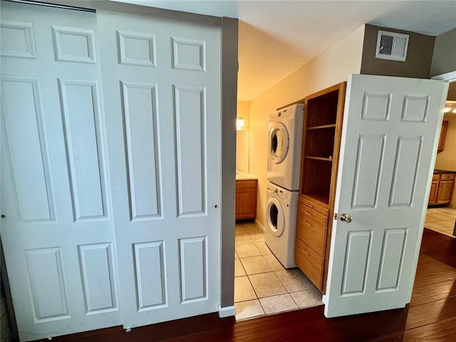 624 Coeur De Royale Dr Unit A, Creve Coeur, MO 63141 - laundry room with stacked washer / dryer and light wood finished floors