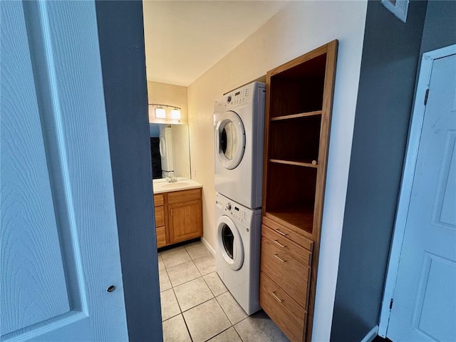 624 Coeur De Royale Dr Unit A, Creve Coeur, MO 63141 - washroom with stacked washer and clothes dryer, light tile patterned floors, and a sink