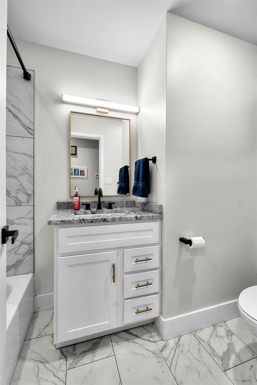 1719 Oak Hills St, Cape Girardeau, MO 63701 - full bathroom featuring marble finish flooring, toilet, baseboards, and vanity