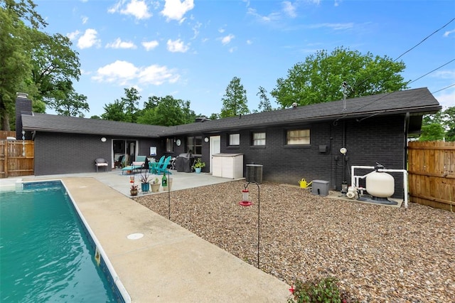1719 Oak Hills St, Cape Girardeau, MO 63701 - back of house with brick siding, central AC unit, and a patio