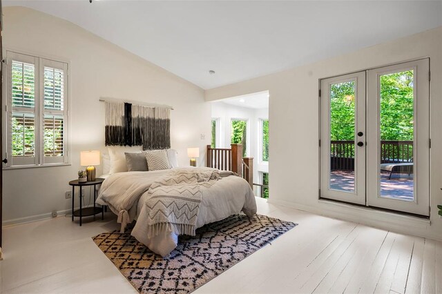 bedroom with access to outside, vaulted ceiling, french doors, and baseboards