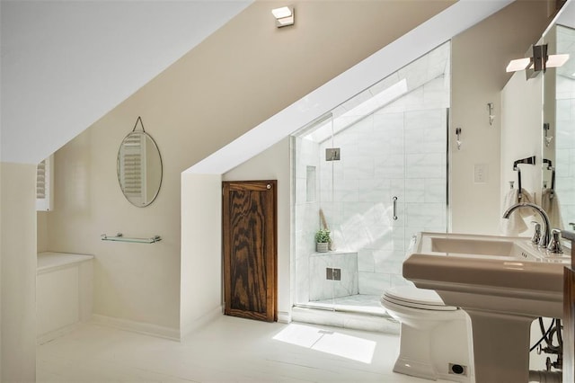 bathroom with toilet, a shower stall, and baseboards