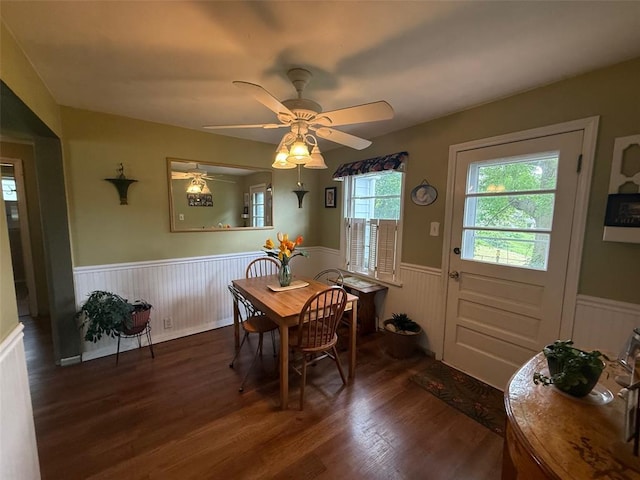dining room featuring a wainscoted wall, wood finished floors, and ceiling fan