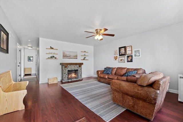 15 W 13th St, Washington, MO 63090 - living room featuring ceiling fan, wood finished floors, a fireplace, and baseboards