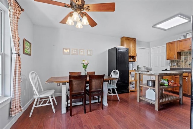 15 W 13th St, Washington, MO 63090 - dining area with dark wood-style floors, a ceiling fan, and baseboards