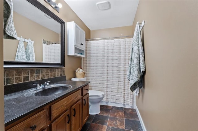 15 W 13th St, Washington, MO 63090 - bathroom featuring backsplash, vanity, baseboards, toilet, and stone finish flooring