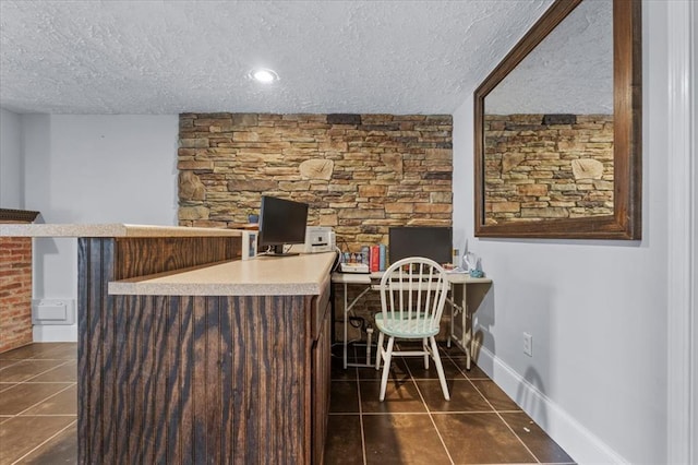15 W 13th St, Washington, MO 63090 - office space with a textured ceiling, dark tile patterned flooring, a bar, and baseboards