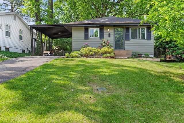 view of front facade featuring asphalt driveway, a front lawn, an attached carport, and entry steps