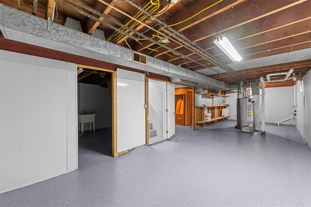unfinished basement with gas water heater