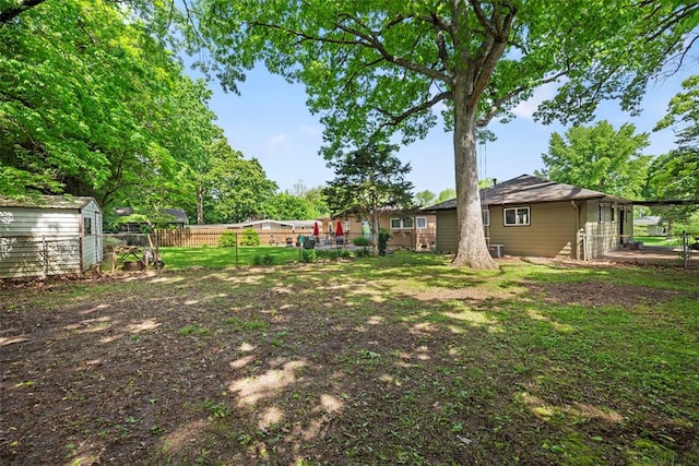 view of yard featuring an outbuilding and a storage unit
