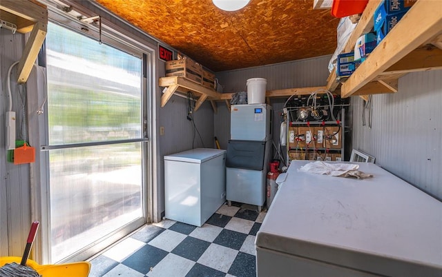 108 College Ave, Licking, MO 65542 - laundry room featuring tile patterned floors and wooden walls