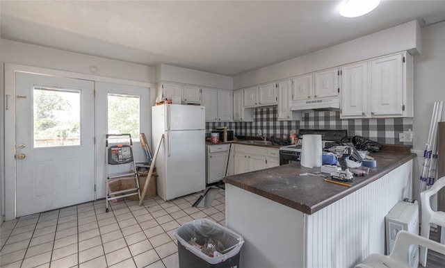 108 College Ave, Licking, MO 65542 - kitchen with freestanding refrigerator, electric range, dark countertops, and under cabinet range hood