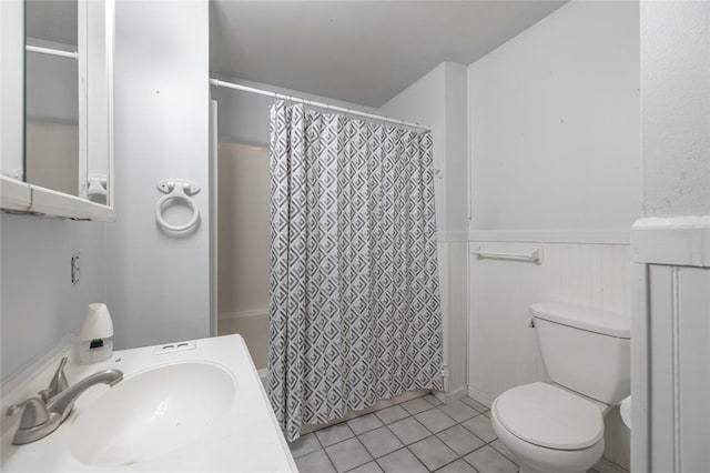 108 College Ave, Licking, MO 65542 - bathroom featuring a sink, a wainscoted wall, toilet, and tile patterned flooring