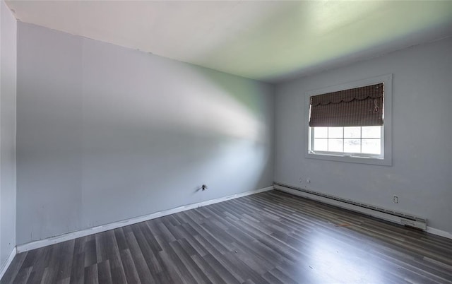 108 College Ave, Licking, MO 65542 - unfurnished room featuring a baseboard radiator, wood finished floors, and baseboards