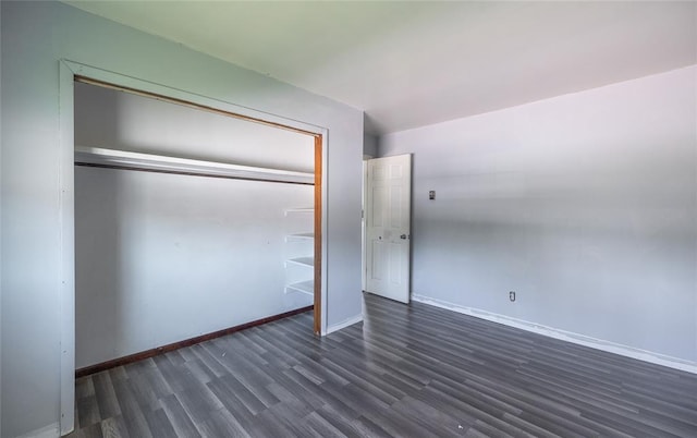 108 College Ave, Licking, MO 65542 - unfurnished bedroom featuring dark wood-style flooring, baseboards, and a closet