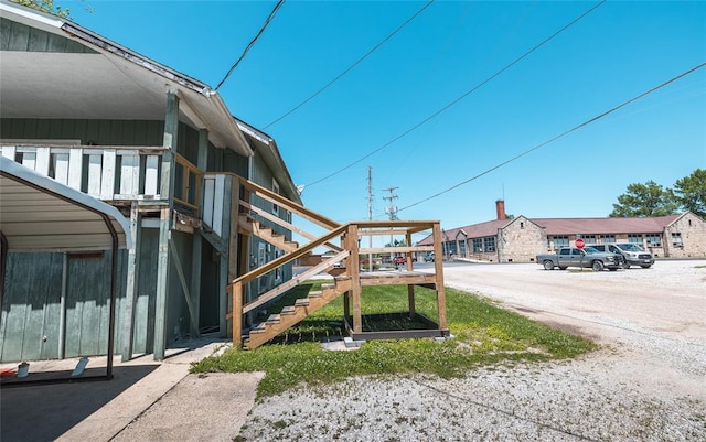 108 College Ave, Licking, MO 65542 - view of building exterior with uncovered parking and stairway