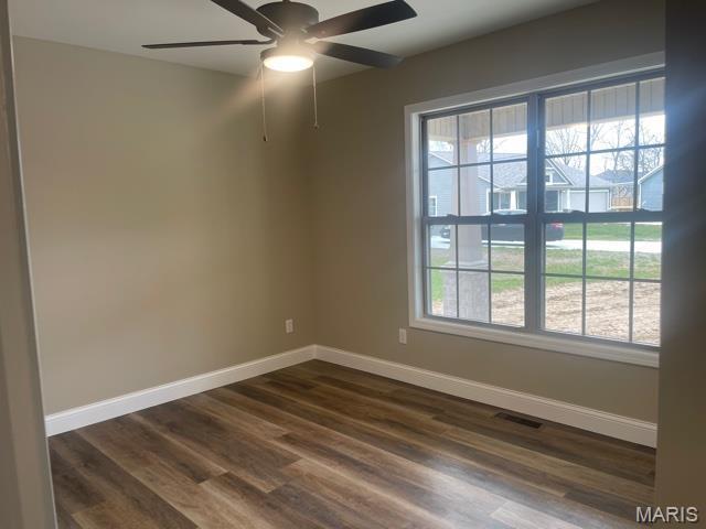 289 Broch Tuarach Pl, Jackson, MO 63755 - empty room with ceiling fan, baseboards, and dark wood-type flooring
