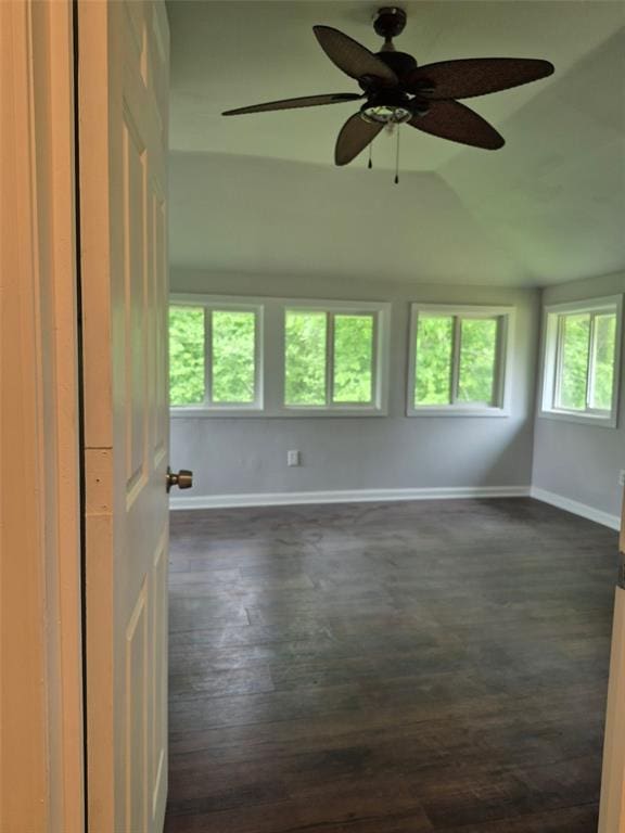 9643 Holtwood Rd, Overland, MO 63114 - unfurnished room with baseboards, dark wood-style floors, ceiling fan, and lofted ceiling