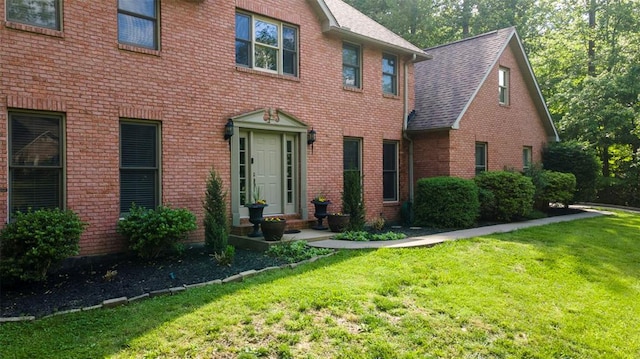 1711 El Rio Dr, Cape Girardeau, MO 63701 - colonial inspired home with a front yard, brick siding, and roof with shingles