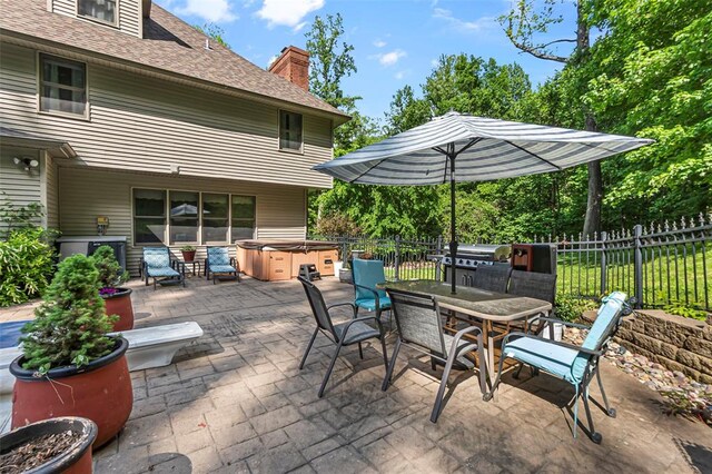 1711 El Rio Dr, Cape Girardeau, MO 63701 - view of patio / terrace featuring a hot tub, fence, outdoor dining space, area for grilling, and exterior kitchen