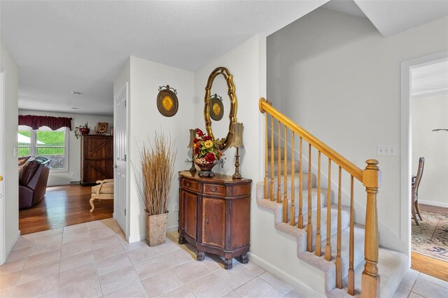 1711 El Rio Dr, Cape Girardeau, MO 63701 - stairs featuring tile patterned flooring and baseboards