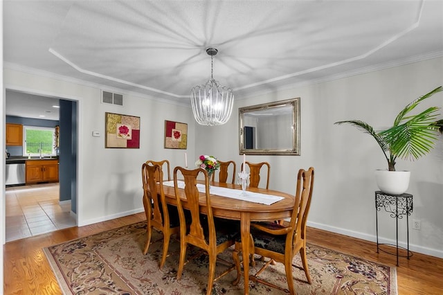1711 El Rio Dr, Cape Girardeau, MO 63701 - dining room with a chandelier, light wood-style floors, ornamental molding, and baseboards