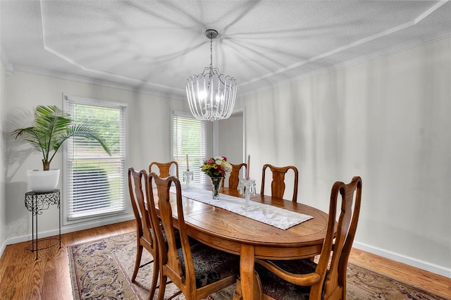 1711 El Rio Dr, Cape Girardeau, MO 63701 - dining area featuring a chandelier, wood finished floors, baseboards, crown molding, and a textured ceiling