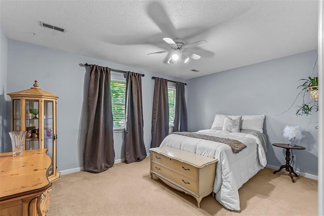 1711 El Rio Dr, Cape Girardeau, MO 63701 - bedroom with light carpet, a textured ceiling, baseboards, and a ceiling fan