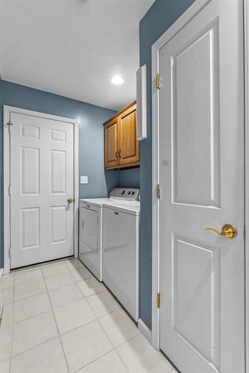 1711 El Rio Dr, Cape Girardeau, MO 63701 - washroom featuring cabinet space, washer and clothes dryer, light tile patterned floors, and recessed lighting