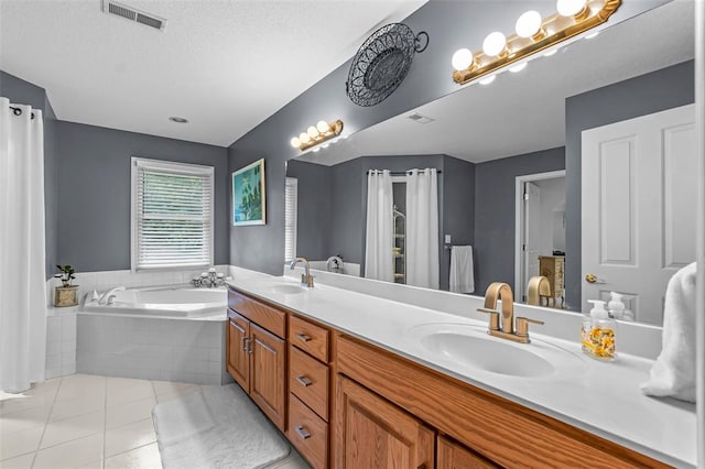 1711 El Rio Dr, Cape Girardeau, MO 63701 - bathroom featuring a garden tub, tile patterned flooring, double vanity, and a textured ceiling