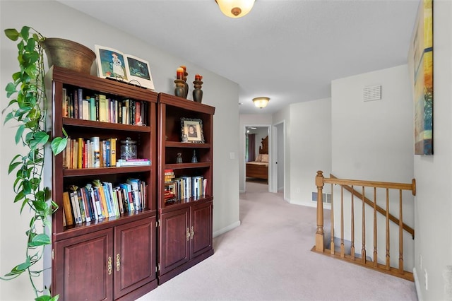 1711 El Rio Dr, Cape Girardeau, MO 63701 - hall featuring an upstairs landing, light carpet, and baseboards