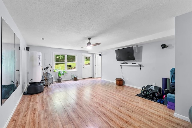 1711 El Rio Dr, Cape Girardeau, MO 63701 - workout area featuring a textured ceiling, wood finished floors, a ceiling fan, and baseboards