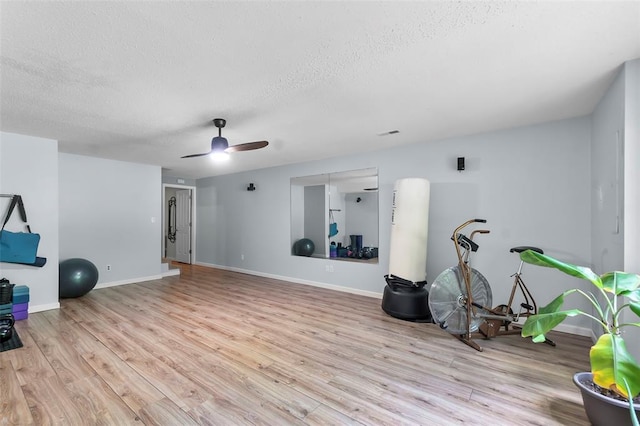 1711 El Rio Dr, Cape Girardeau, MO 63701 - exercise room featuring a textured ceiling, light wood finished floors, baseboards, and ceiling fan