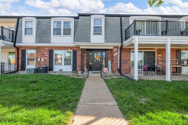 853 Dumont Pl Unit A, Saint Louis, MO 63125 - townhome / multi-family property with mansard roof, brick siding, and a front yard