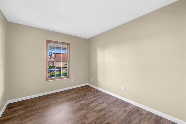 853 Dumont Pl Unit A, Saint Louis, MO 63125 - spare room with dark wood-type flooring and baseboards
