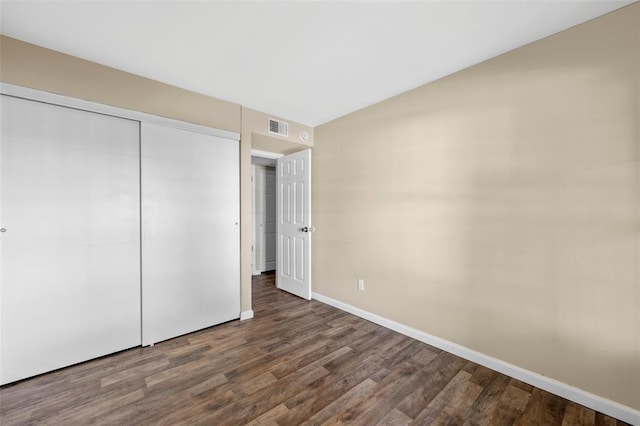 853 Dumont Pl Unit A, Saint Louis, MO 63125 - unfurnished bedroom featuring baseboards, wood finished floors, and a closet