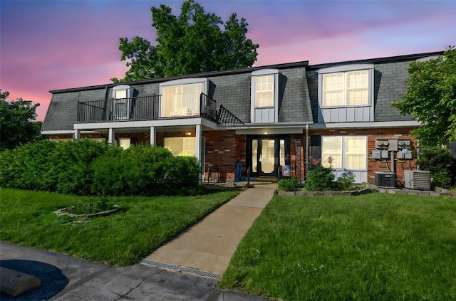 853 Dumont Pl Unit A, Saint Louis, MO 63125 - view of front of property featuring a balcony, mansard roof, brick siding, a front yard, and central AC