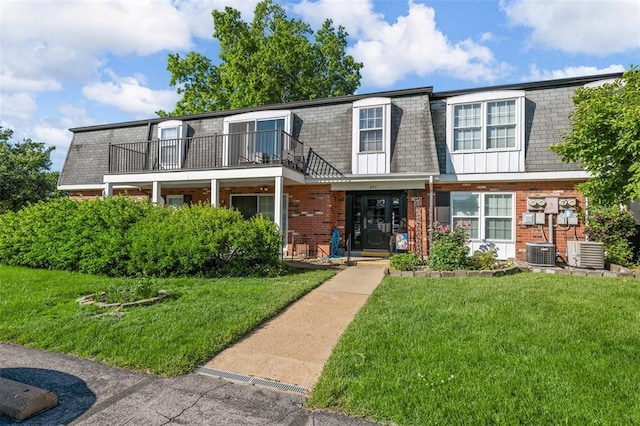 853 Dumont Pl Unit A, Saint Louis, MO 63125 - multi unit property featuring mansard roof, brick siding, a balcony, a front lawn, and cooling unit