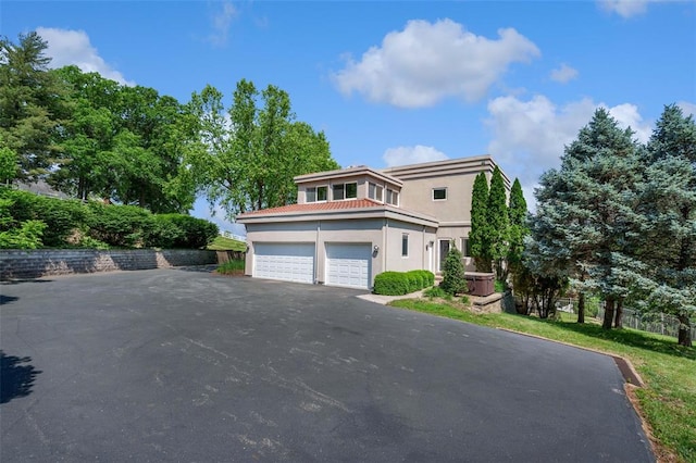 169 Fick Farm Rd, Chesterfield, MO 63005 - view of front of property with asphalt driveway, stucco siding, a garage, and a tile roof