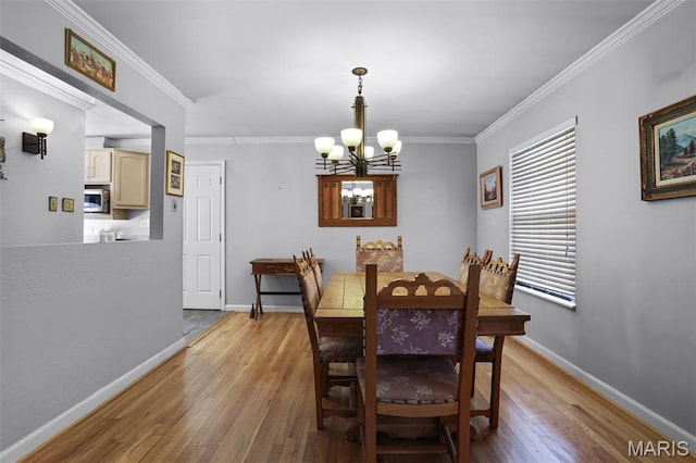 12036 Orchard View Dr, Creve Coeur Township, MO 63146 - dining room with a chandelier, light wood-style flooring, and ornamental molding