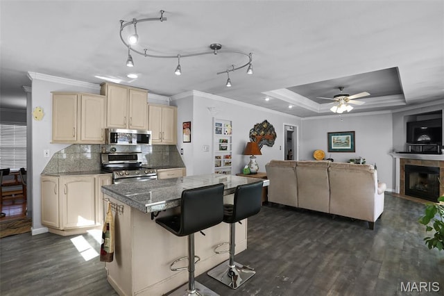 12036 Orchard View Dr, Creve Coeur Township, MO 63146 - kitchen with stainless steel appliances, open floor plan, cream cabinets, dark wood-style flooring, and a center island
