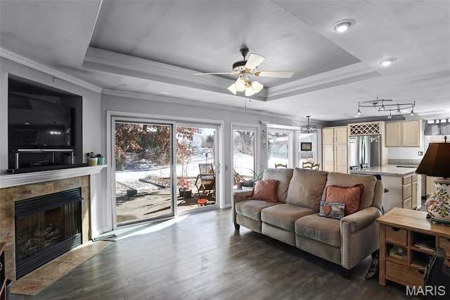 12036 Orchard View Dr, Creve Coeur Township, MO 63146 - living area featuring a raised ceiling, ceiling fan, dark wood-type flooring, a tile fireplace, and crown molding