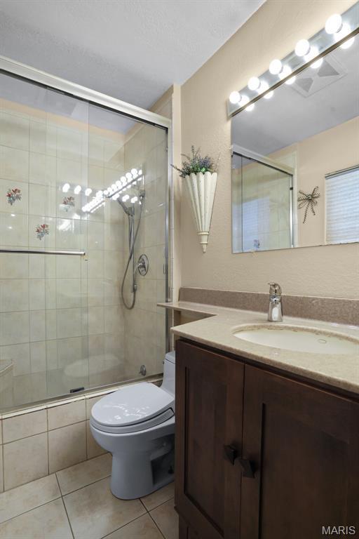 12036 Orchard View Dr, Creve Coeur Township, MO 63146 - full bathroom with tile patterned flooring, vanity, and a tile shower