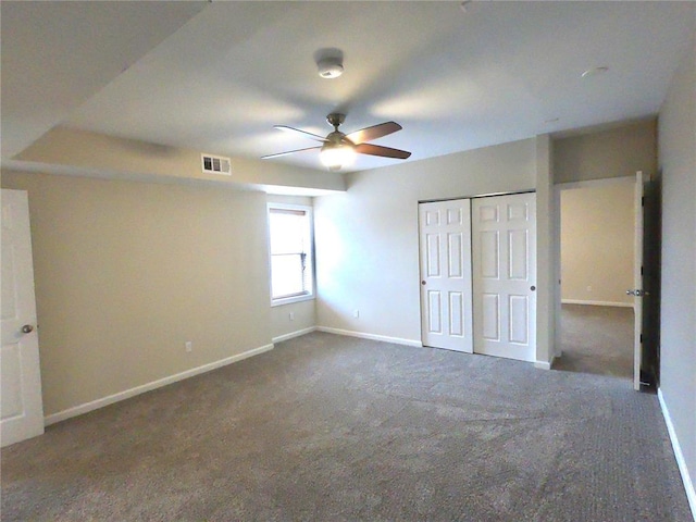 3606 Iowa Ave, Saint Louis, MO 63118 - unfurnished bedroom with baseboards, dark carpet, a closet, and a ceiling fan