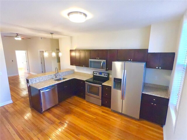 3606 Iowa Ave, Saint Louis, MO 63118 - kitchen with appliances with stainless steel finishes, light wood finished floors, a sink, light countertops, and ceiling fan
