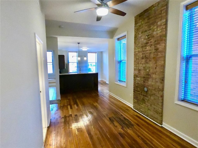 3606 Iowa Ave, Saint Louis, MO 63118 - unfurnished living room with dark wood-style floors, ceiling fan, plenty of natural light, and baseboards